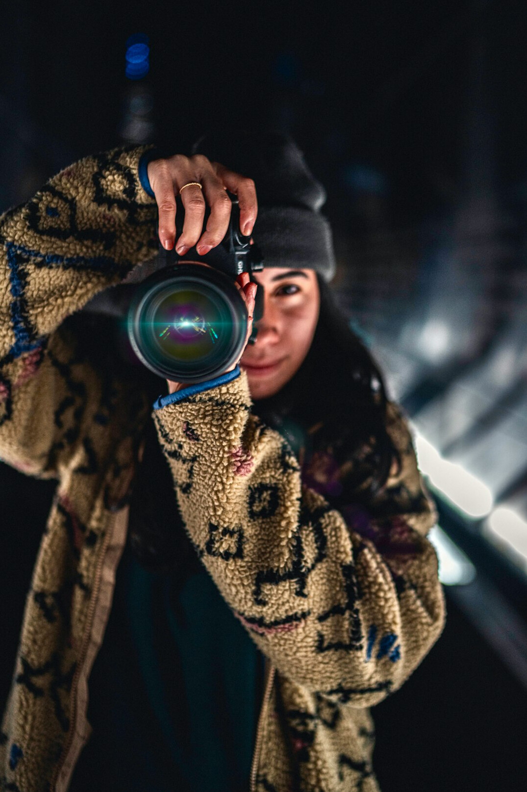 Portrait of a young female documentary photographer holding a camera