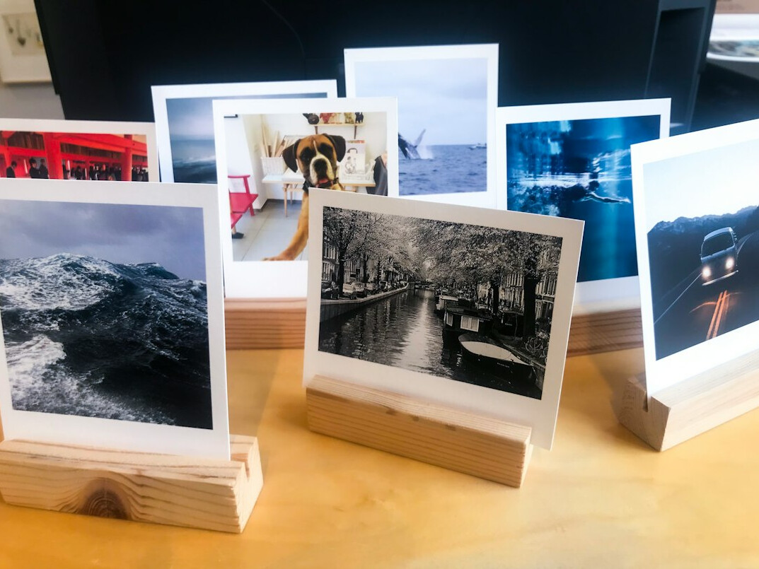 Contact sheets and printed photographs spread on an editing desk