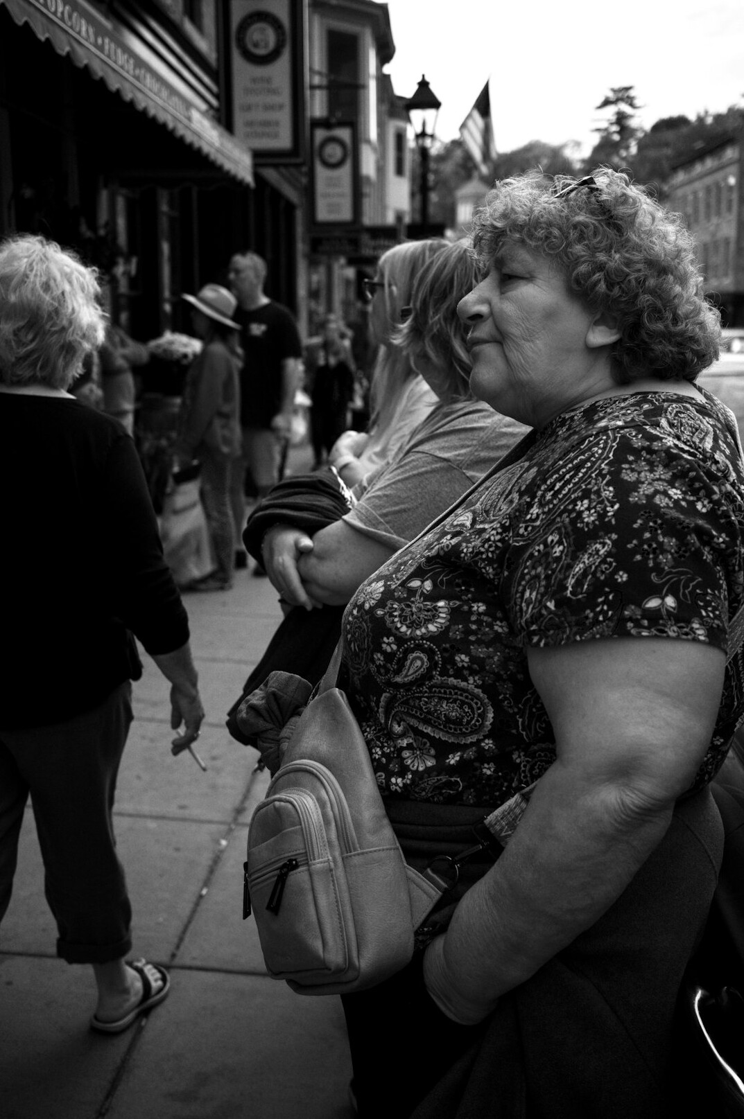 Documentary photographer talking with an elderly woman on a small town street