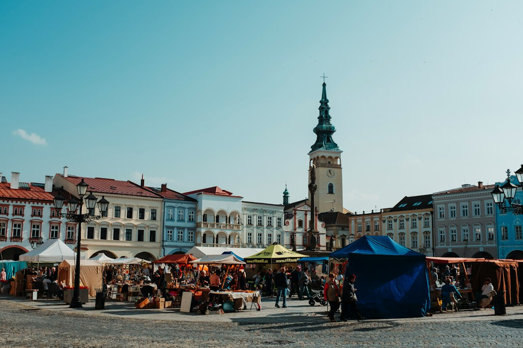 Vendors and shoppers at a traditional Polish town market square
